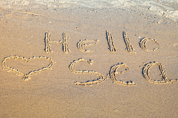 Hello Sea written in the sand.