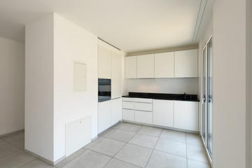 White kitchen with windows in modern apartment