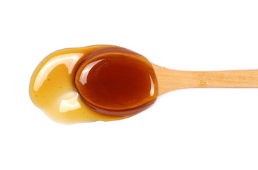 Honey with wooden spoon isolated on white background, top view