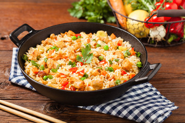 Fried rice with chicken. Prepared and served in a wok.