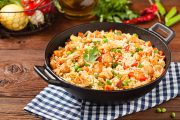 Fried rice with chicken. Prepared and served in a wok.