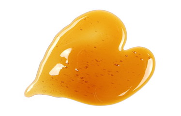 Honey in heart shape isolated on white background, top view