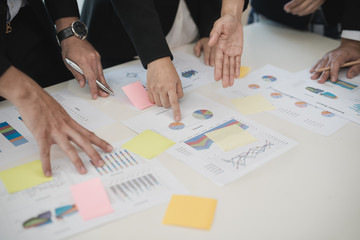 Hand of Business man and Business woman working on Data Charts,document  at office desk. analyzing brainstorming, meeting concept..