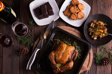 Christmas and new year's eve dinner: roasted whole chicken / turkey, sauteed cubed sweet potato, chocolate chip cookies, chocolate coated biscuits, and red wine