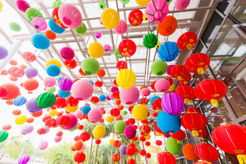 Fototapeta na wymiar Colorful folding paper lantern on the ceiling with fair,Chinese new year
