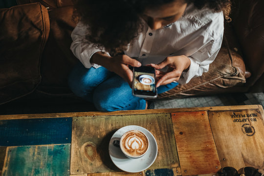 Woman taking shot of latte