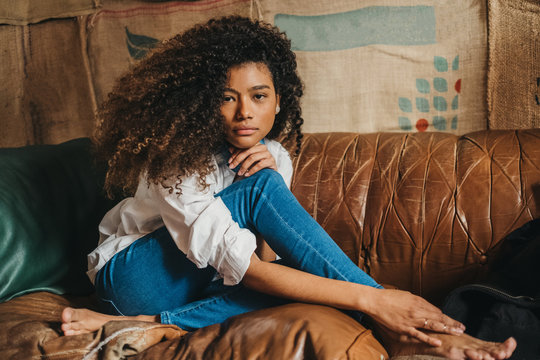 Portrait of stylish woman sitting on couch