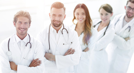 Fototapeta premium Portrait of medical team standing with arms crossed in hospital