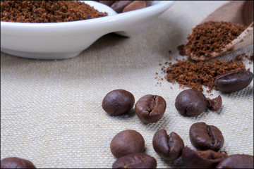 Closeup of coffee beans and roasted coffee heap. Arabic roasting coffee - ingredient of hot beverage.