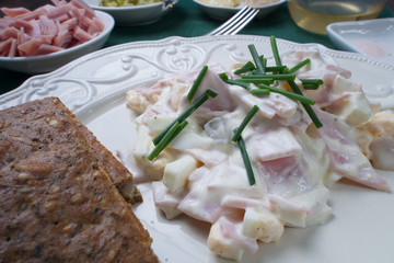 Fresh French salad from ham, eggs and vegetable with cream and homemade seed bread
