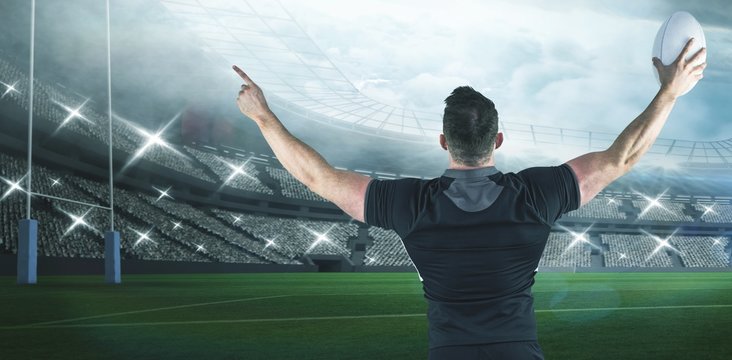 Composite image of rugby player celebrating with the ball