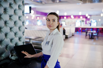 Waiter girl working with pos terminal or cashbox at cafe. People and service concept