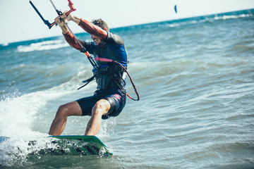 Kitesurfing Kiteboarding action photos man among waves quickly goes