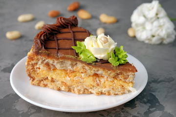 Slice of traditional ukrainian Kiev cake on saucer. Homemade baking.
