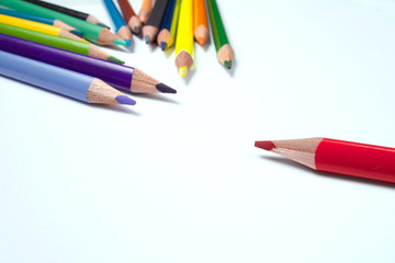 Business concepts: red crayon standing out from the crowd