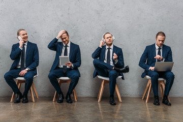 collage of cloned young businessman sitting on chairs and using gadgets