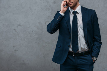 cropped shot of handsome businessman talking by phone