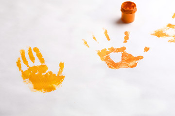 on white background bank with paint and prints of children's hands drawing with hands