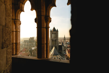 view through ancient window at beautiful historical cityscape of Ghent, Belgium