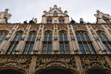 Fototapeta na wymiar low angle view of beautiful old building with sculptures in mechelen, belgium