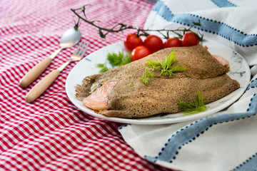 Homemade french salmon buckwheat galette on the table