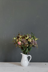 Fototapeta na wymiar A bouquet of flowers in a jug