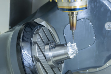 The table tilt type 5 axis CNC milling machine cutting the turbine part with solid end mill tool.
