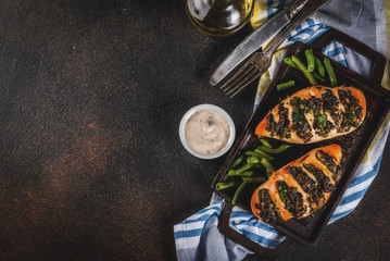 Healthy dinner, Pollo a fisarmonica con ricotta e spinaci, chicken fillet baked with cheese and spinach. On grill pan, with sauce and fresh vegetables. copy space