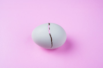 broken egg on pink ground