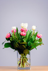 bouquet of white and pink tulips in front of bright  backgroun