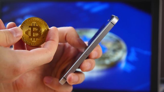 Trade in the house crypto currency. Close-up of a smartphone and coins of Litecoin LTC, BitCoin BTS, Ethereum ETX, and Ripple, XRP