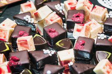 chocolate candy with filling, nuts and fruits. Real bitter chocolate