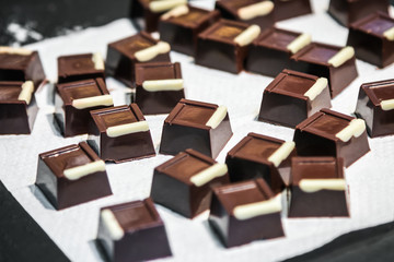 chocolate candy with filling, nuts and fruits. Real bitter chocolate