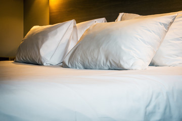 Pillows on a large king-size bed. Concept on preparation of the bed in a hotel room or at home