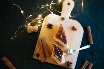 Cake on a wooden tray on a black matte background