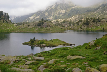 Fototapeta na wymiar Lake in the mountains in a foggy day