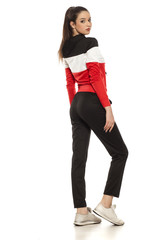 Fototapeta premium young women in black and red tracksuits on a white background