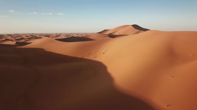 Aerial view on sand dunes in Sahara desert at sunrise, Africa, 4k
