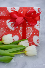 Close-up tulips and gift box with heart