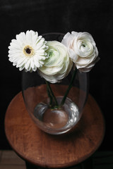 flower Ikibana on a black background, bouquet in a glass vase