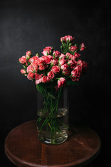 flower Ikibana on a black background, bouquet in a glass vase