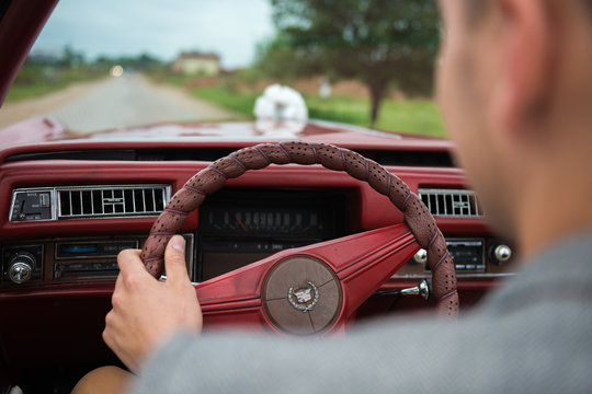 Man Driving The Old Vintage Red Car