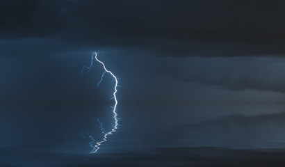 lightning bolts reflection over the sea. taken during a thunderstorm over the ocean with clouds in...