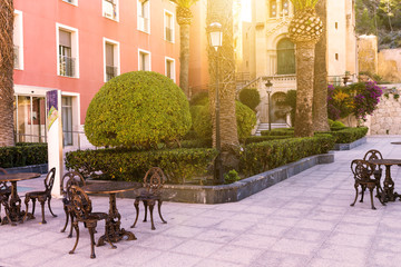 Tables and chairs in a beautiful street European cafe