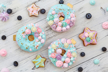 Fototapeta na wymiar Colorful donuts on white wooden background