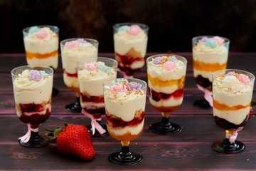 Cake with strawberry served in glass shots