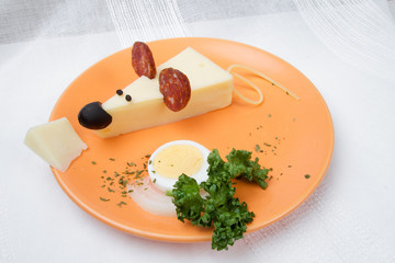 Cheese mouse with sausage and vegetal on the plate