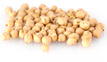 Pile of chickpeas against white background.