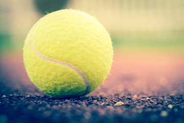Sport Item concept : Tennis balls at red court in summer day. Tennis is racket sport that can be...