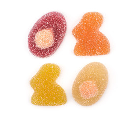 Jelly Easter pattern top view isolated on white background marmalade sweets bunny and egg shapes.